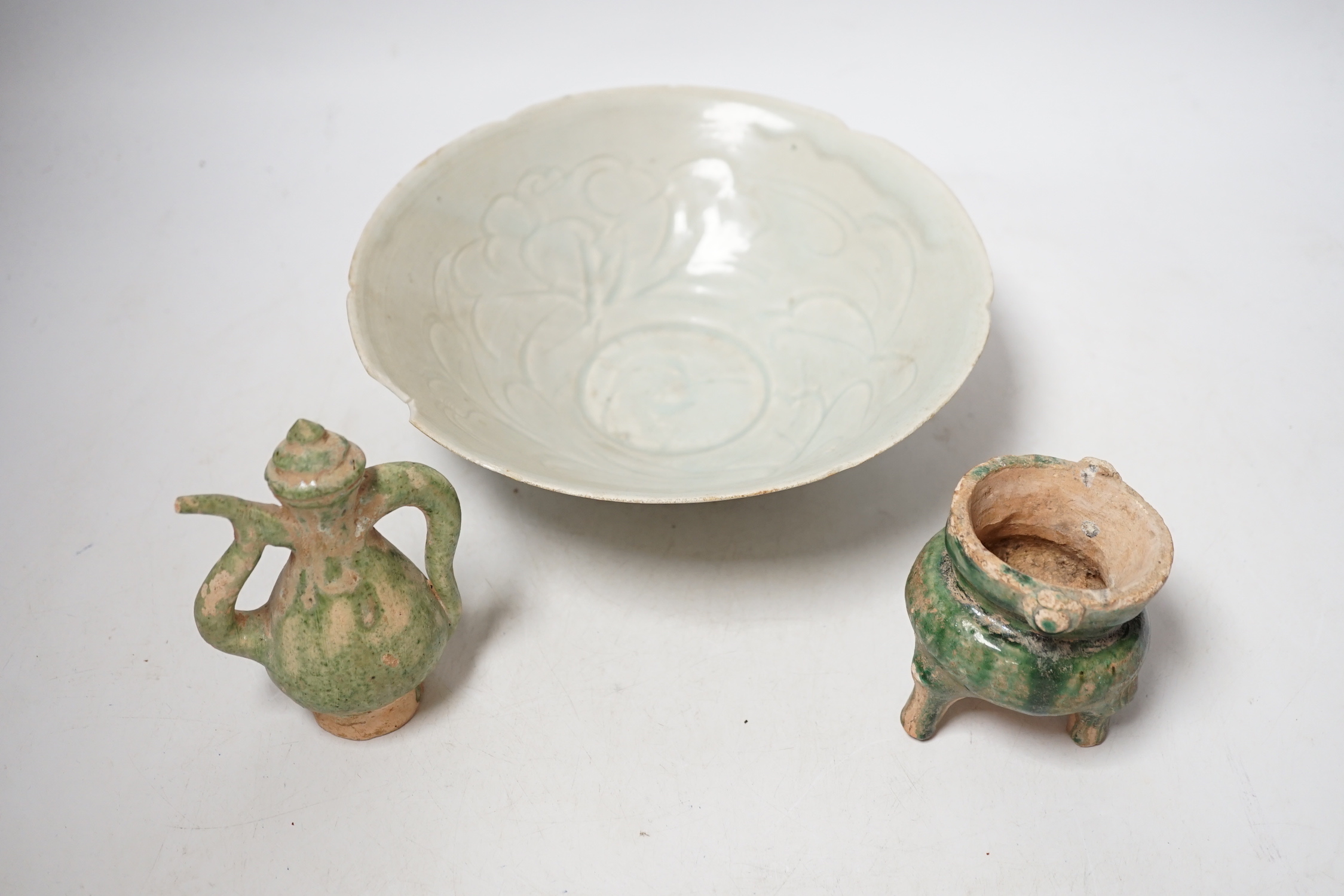 A Chinese incised Qingbai bowl, Song Dynasty and two green glazed Ming Dynasty pottery models of vessels, bowl 20cm diameter